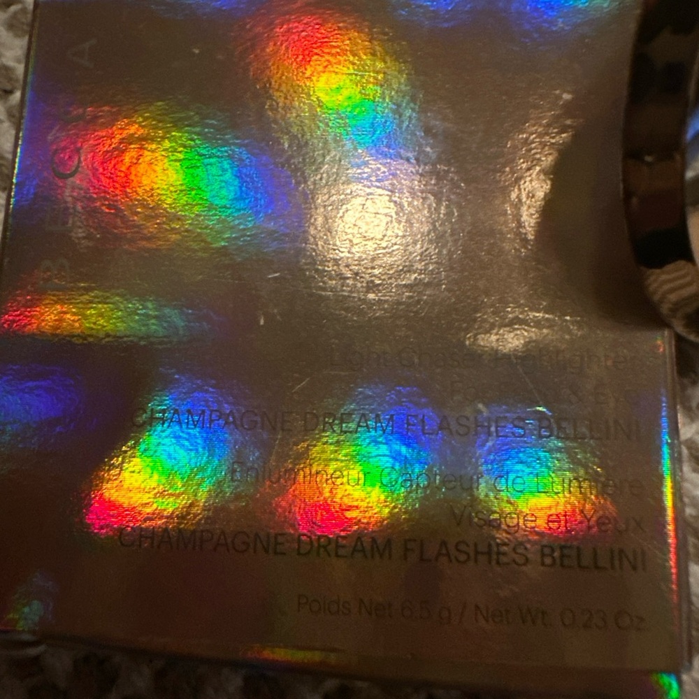 BECCA Light Chaser Highlighter in champagne dream flashes Bellini